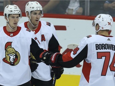 Thomas Chabot, Kyle Turris and Mark Borowiecki (from left) of the Ottawa Senators celebrate a goal against the Winnipeg Jets.