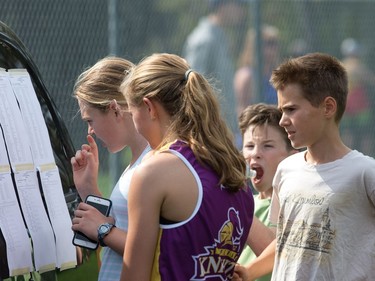 Girls and boys check the finishings as the 2017 Gryphon Open Cross Country Meet takes place Wednesday at the Terry Fox Athletic Facility.