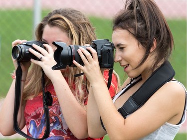 Glebe team photographers Natalie Woulfe, 16, and Nicole Jakubek, 16, look for a winning shot as the 2017 Gryphon Open Cross Country Meet takes place Wednesday at the Terry Fox Athletic Facility.