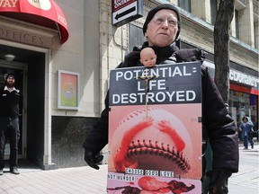 A protester stands outside the Morgentaler Clinic at 65 Bank St.