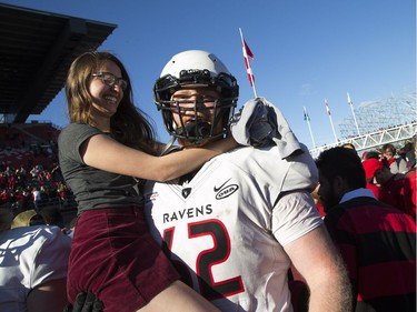 Carleton Ravens #62 KC Bakker celebrates with his girlfriend after they won the Panda Game against the uOttawa Gee-Gees at TD Place Saturday September 30, 2017.