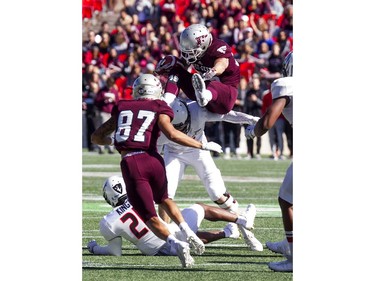 Carleton Ravens won the Panda Game against the uOttawa Gee-Gees at TD Place Saturday September 30, 2017. Gee-Gees #25 Bryce Vieira flies over a Ravens player.