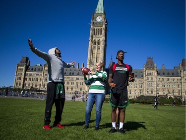 The Saskatchewan Roughriders held a practice on Parliament Hill Sunday October 1, 2017 in Ottawa, after playing the Redblacks Friday night. Roughriders fan Donna Kitchen was having all the fun as she caught a pass.   Ashley Fraser/Postmedia