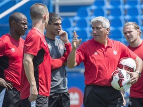 Canadian men's soccer team coach Octavio Zambrano is seen here with players during a June training session in Montreal. THE CANADIAN PRESS/Paul Chiasson