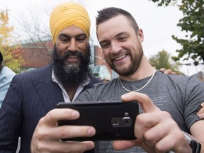 NDP Leader Jagmeet Singh, left, poses for a photo with local resident Mathieu Dallaire, during a campaign visit for local candidate Gisele Dallaire, Tuesday, October 10, 2017 in Alma Que.