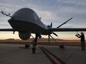 Maintenance personnel check a Predator drone operated by U.S. Office of Air and Marine (OAM), before its surveillance flight near the Mexican border on March 7, 2013 from Fort Huachuca in Sierra Vista, Arizona.