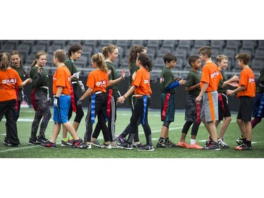 The CFL and NFL launched a flag football program of coed teams of 11-12-year olds to take part in nine regional tournaments to be held in CFL cities, coming together for a national tournament during Grey Cup week in the nation's capital. Two teams shake hands at the end of a round robin game at TD Place Sunday October 15, 2017.    Ashley Fraser/Postmedia
Ashley Fraser, Postmedia