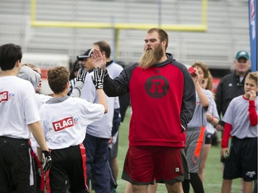 Jon Gott, offensive lineman for the Ottawa Redblacks was on the field motivating the young players at TD Place Sunday October 15, 2017.