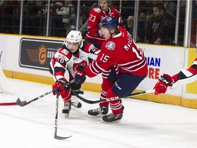 67's defenceman Kevin Bahl tries to stop the Generals' Kyle MacLean during the first period at TD Place arena on Friday night.