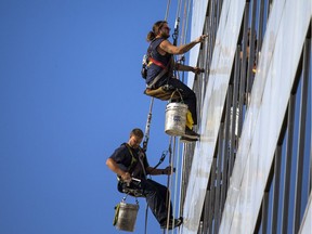 Window washers take advantage of the beautiful fall weather on Saturday, Oct. 21, 2017, to get a west-end government building all shined up.