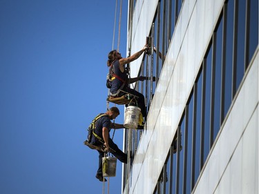 Window washers take advantage of the beautiful fall weather on Saturday, Oct. 21, 2017, to get a west-end government building all shined up.