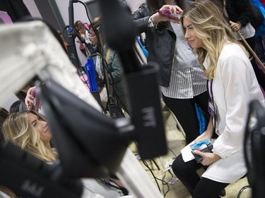 Melisa Caron gets her hair curled at the National Women's Show that took place Saturday, Oct. 21, 2017 at the EY Centre.