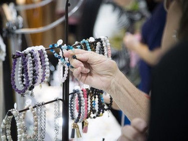 A woman looks at Love Montreal Jewelry at the National Women's Show.