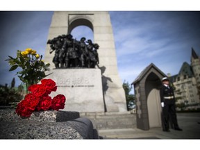 Today, Sunday October 22, 2017 people paid their respects at the Canadian Tomb of the Unknown Soldier and paused for a moment of reflection around the area of the cenotaph.   Ashley Fraser / Postmedia