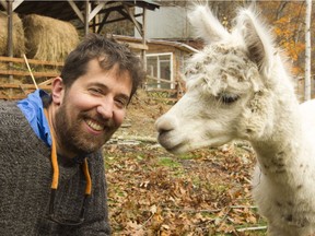 Mike Caldwell with Snowflake, one of his herd of six alpacas. Caldwell is selling the entire herd for $250.