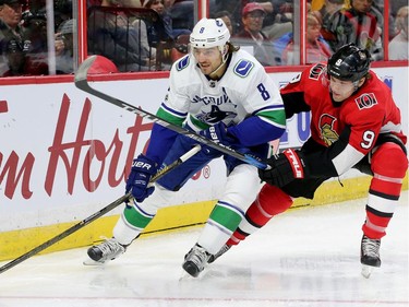 Ottawa's Bobby Ryan (right) battles for the puck with Vancouver's Christopher Tanev behind Vancouver's net during first-period action between the Ottawa Senators (red) and the Vancouver Canucks Tuesday (October 17, 2017) at Canadian Tire Centre. Julie Oliver/Postmedia