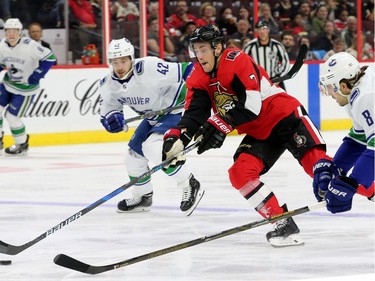 Ottawa's Kyle Turris drives the puck past Vancouver's Alexander Burmistrov (left) and Christopher Tanev (right) during first-period action between the Ottawa Senators (red) and the Vancouver Canucks Tuesday (October 17, 2017) at Canadian Tire Centre. Julie Oliver/Postmedia