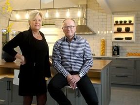 Paul St-Germain, who runs a business called Swedish Door that makes doors and accessories to fit with IKEA kitchens, and designer Kim Teron stand inside one of the kitchens they put together during a renovation at a home on Prince of Wales.