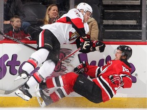 The Senators' Mark Borowiecki flattens the Devils' Jacob Josefson during a game in February 2017.