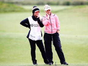 Brooke Henderson (right) lines up a putt with her caddy and sister, Brittany Henderson, at the New Zealand Women's Open on Oct. 2.