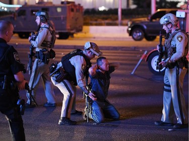 Police officers stop a man who drove down Tropicana Ave. near Las Vegas Boulevard and Tropicana Ave, which had been closed after a mass shooting at a country music festival that left at least 2 people dead nearby on October 2, 2017 in Las Vegas, Nevada. The man was released.