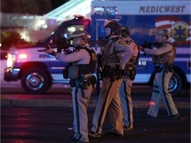 Police officers point their weapons at a car driving down closed Tropicana Ave. near Las Vegas Boulevard after a reported mass shooting at a country music festival nearby on October 2, 2017 in Las Vegas, Nevada.  A gunman has opened fire on a music festival in Las Vegas, leaving at least 2 people dead. Police have confirmed that one suspect has been shot. The investigation is ongoing.