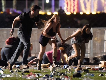 People run from the Route 91 Harvest country music festival after apparent gun fire was hear on October 1, 2017 in Las Vegas, Nevada. A gunman has opened fire on a music festival in Las Vegas, leaving at least 20 people dead and more than 100 injured. Police have confirmed that one suspect has been shot. The investigation is ongoing.