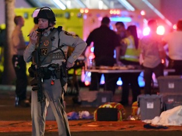 A Las Vegas Metropolitan Police officer stands in the intersection of Las Vegas Boulevard and Tropicana Ave. after a mass shooting at a country music festival nearby on October 2, 2017 in Las Vegas, Nevada. A gunman has opened fire on a music festival in Las Vegas, killing over 20 people. Police have confirmed that one suspect has been shot dead. The investigation is ongoing.