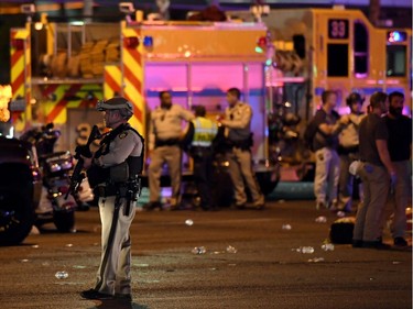 A Las Vegas Metropolitan Police Department officer stands in the intersection of Las Vegas Boulevard and Tropicana Ave. after a mass shooting at a country music festival nearby on October 2, 2017 in Las Vegas, Nevada. A gunman has opened fire on a music festival in Las Vegas, leaving at least 20 people dead and more than 100 injured. Police have confirmed that one suspect has been shot. The investigation is ongoing.