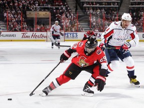 Senators defenceman Johnny Oduya knocks the puck away from a streaking Alex Ovechkin in the first period at the Canadian Tire Centre on Thursday, Oct. 5, 2017.