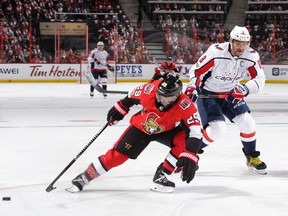 Johnny Oduya #29 of the Ottawa Senators knocks the puck away from a streaking Alex Ovechkin #8 of the Washington Capitals in the first period at Canadian Tire Centre on October 5, 2017.