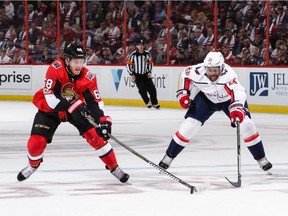 Mike Hoffman of the Senators skates with the puck against Devante Smith-Pelly of the Capitals in the first period of Thursday's season opener. Jana Chytilova/Getty Images