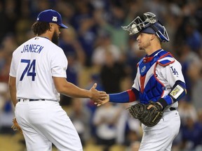 Dodgers catcher Yasmani Grandal, right, shakes hands with relief pitcher Kenley Jansen after the team's 9-5 victory against the Diamondbacks in Game 1 of the National League Division Series on Oct. 6. Sean M. Haffey/Getty Images