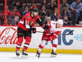 Ben Harpur of the Senators has his stick held by Gustav Nyquist of the Red Wings in the first period of Saturday's game. Harpur, himself a call-up from the AHL because of injury, was hurt late in the game and is out of the lineup for at least the start of this week's road trip through Western Canada. Jana Chytilova/Getty Images