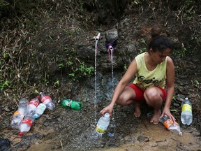 Puerto Rico Faces Extensive Damage After Hurricane Maria

UTUADO, PUERTO RICO - OCTOBER 10:  Yanira Rios collects spring water for use in her house, which is without running water or electricity, nearly three weeks after Hurricane Maria hit the island, on October 10, 2017 in Utuado, Puerto Rico. Most of the municipality is without running water or grid power. Only 16 percent of Puerto Rico's grid electricity has been restored. Puerto Rico experienced widespread damage including most of the electrical, gas and water grid as well as agriculture after Hurricane Maria, a category 4 hurricane, swept through.  (Photo by Mario Tama/Getty Images)
Mario Tama, Getty Images