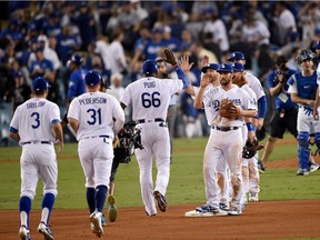 Dodgers players celebrate on the field after defeating the Cubs in Game 1 of the National League Championship Series on Saturday night. Kevork Djansezian/Getty Images