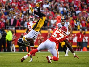 Wide receiver Antonio Brown #84 of the Pittsburgh Steelers is upended by linebacker Kevin Pierre-Louis #57 of the Kansas City Chiefs after a catch over the middle during the second half of the game at Arrowhead Stadium on October 15, 2017 in Kansas City, Missouri.