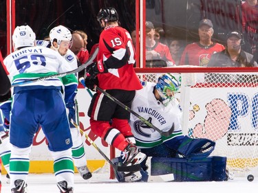 Zack Smith #15 of the Ottawa Senators jumps out of the way as Anders Nilsson #31 of the Vancouver Canucks makes a pad save in the first period at Canadian Tire Centre on October 17, 2017 in Ottawa, Ontario, Canada.  (Photo by Jana Chytilova/Freestyle Photography/Getty Images)