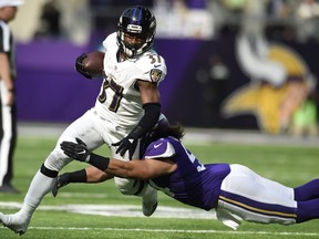 Javorius Allen #37 of the Baltimore Ravens is tackled with the ball by Eric Kendricks #54 of the Minnesota Vikings in the first half of the game on October 22, 2017 at U.S. Bank Stadium in Minneapolis, Minnesota. (Photo by Hannah Foslien/Getty Images)