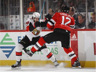 Max McCormick of the Senators stops Ben Lovejoy of the Devils during the first period.  Bruce Bennett/Getty Images