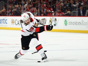 Senators captain Erik Karlsson breaks his stick taking a third-period shot against the Devils on Friday night. Bruce Bennett/Getty Images