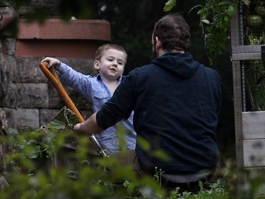 Joshua Boyle and son Jonah play in the garden.