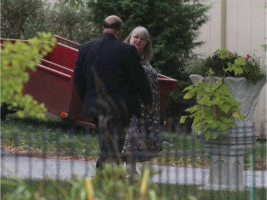 Linda Boyle, mother of Joshua Boyle, talks to security outside their house in Smith Falls.