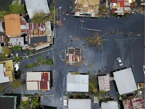 PUERTORICO-CARIBBEAN-WEATHER-HURRICANE

An aerial view shows the flooded neighbourhood of Juana Matos in the aftermath of Hurricane Maria in Catano, Puerto Rico, on September 22, 2017. Puerto Rico battled dangerous floods Friday after Hurricane Maria ravaged the island, as rescuers raced against time to reach residents trapped in their homes and the death toll climbed to 33. Puerto Rico Governor Ricardo Rossello called Maria the most devastating storm in a century after it destroyed the US territory's electricity and telecommunications infrastructure.  / AFP PHOTO / Ricardo ARDUENGORICARDO ARDUENGO/AFP/Getty Images
RICARDO ARDUENGO, AFP/Getty Images