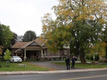 Security guards stand outside the home of Joshua Boyle's parents in Smiths Falls.