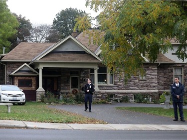 Security personnel stand outside the home of freed Canadian hostage Joshua Boyle's parents in Smiths Falls on October 14, 2017.