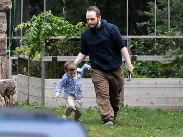 Freed Canadian hostage Joshua Boyle and his son, Jonah, walk outside his parents' home in Smiths Falls.