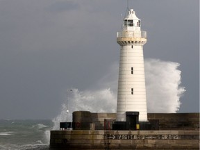 The sea breaks over the harbour behind Donaghadee lighthouse on the Irish Sea coast, east of Belfast in Northern Ireland, on October 16, 2017 as Northern Ireland braces for the passing of the storm Ophelia. Schools were closed on October 16 as Ireland and Northern Ireland braced for an "unprecedented storm", with authorities warning that violent winds, rain and storm surges could pose a risk to life. Ophelia, the largest hurricane ever recorded so far east in the Atlantic Ocean, was downgraded to a storm before it hit the Irish coast but the Met Eireann national weather service warned people to remain indoors.  / AFP PHOTO / Paul FAITHPAUL FAITH/AFP/Getty Images
PAUL FAITH, AFP/Getty Images