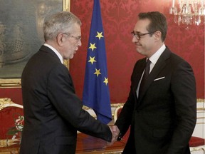 Austrian President Alexander van der Bellen, left, welcomes Heinz-Christian Strache, chairman of the right-wing Freedom Party, FPOE, for talks following Sunday's election at the Hofburg palace in Vienna, Austria, Wednesday, Oct. 18, 2017. (AP Photo/Ronald Zak)