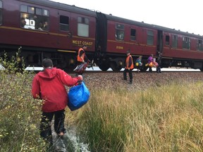 In this photo taken on Friday, Oct. 13, 2017, children run towards a train near Loch Eilt in  the Scottish Highlands. As if by magic, the Hogwarts Express has come to the rescue of a stranded family in Scotland.